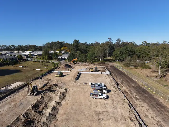 Aerial view of earthworks, retaining walls and service trenches under construction at Harry Street, Bellbird Park.
