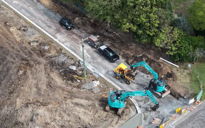 Excavators building new kerb and road works along the frontage of the Halletts Road subdivision, Redbank Plains.